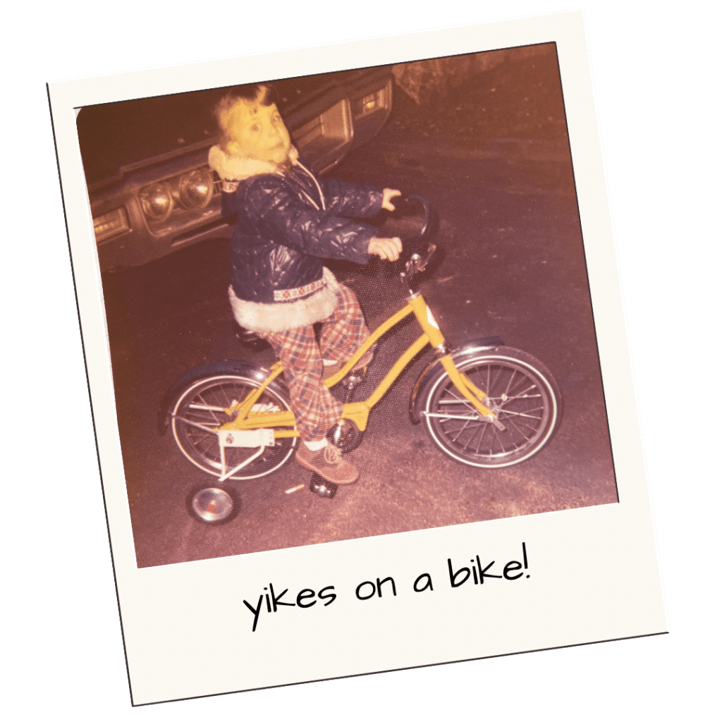 Very nervous young Dawn on a yellow bike with training wheels